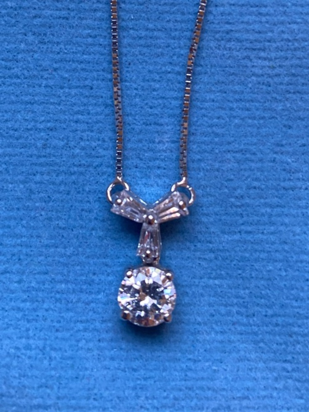 Silver Toned Bow Pendant Necklace with Sparkling Clear Crystal Drop